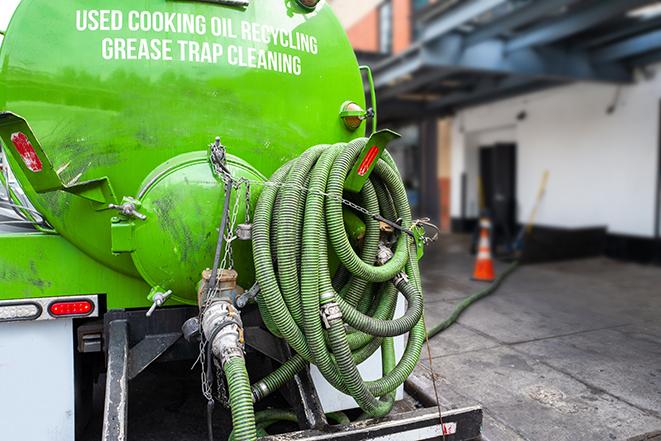 grease trap pumping truck servicing a restaurant in Bedford, TX